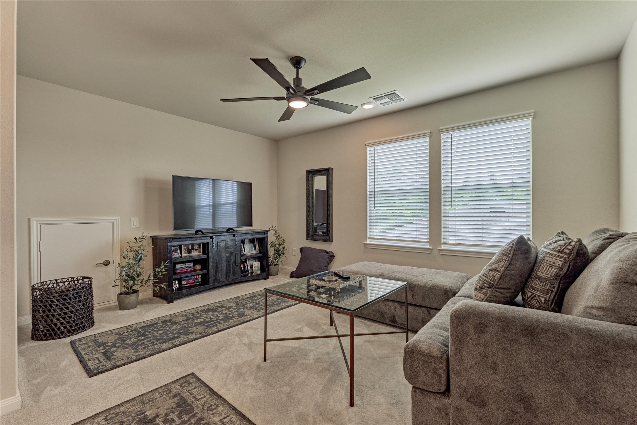 128 Caspian Way Spring Spring, TX 77382 - Photo 28 of 48 a living room with furniture a flat screen tv and a large window