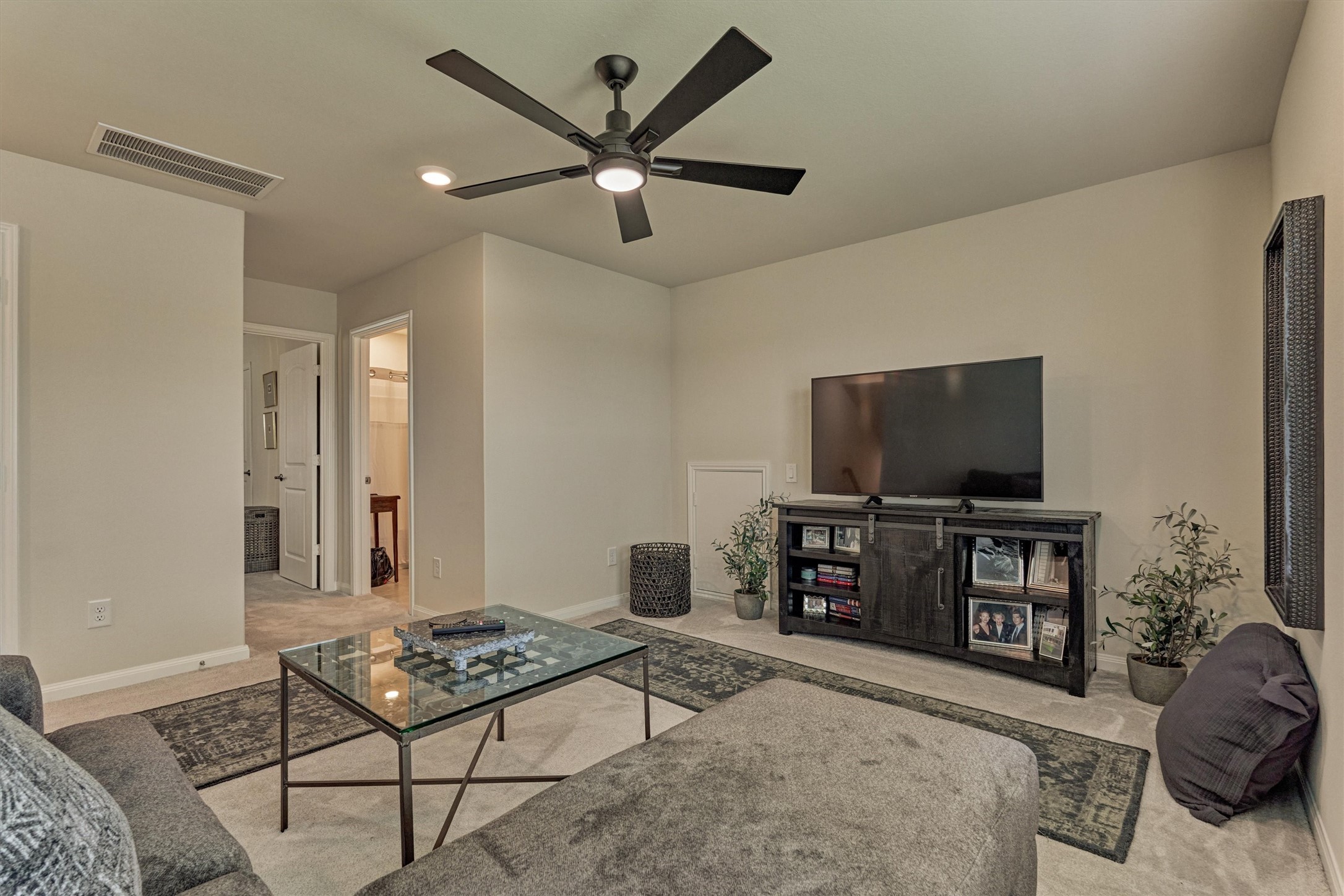 128 Caspian Way Spring Spring, TX 77382 - Photo 29 of 48 a living room with furniture and a flat screen tv