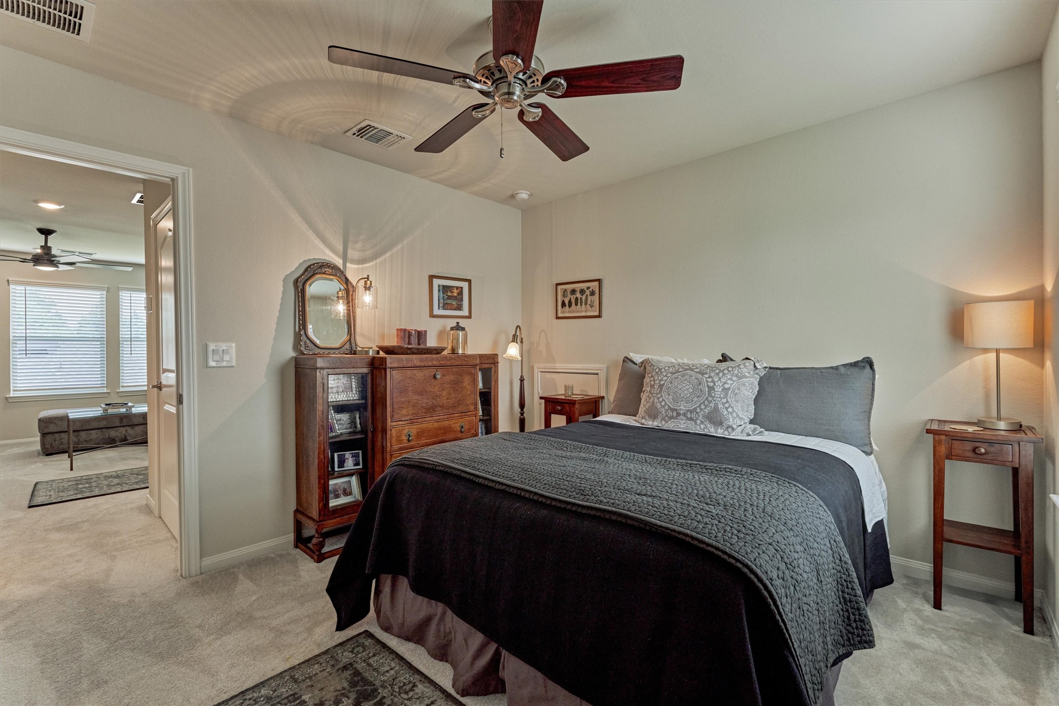 128 Caspian Way Spring Spring, TX 77382 - Photo 32 of 48 a bedroom with a large bed and a chandelier
