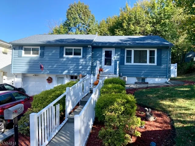 a front view of a house with yard and porch