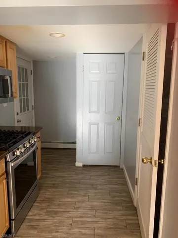 a kitchen with granite countertop a refrigerator stove top oven and sink