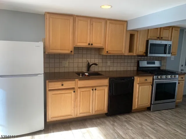 a view of a house with a yard and a garage