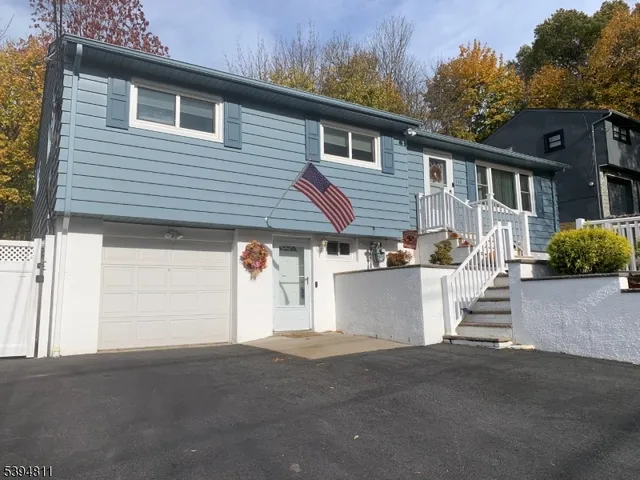 a view of a house with a yard and potted plants