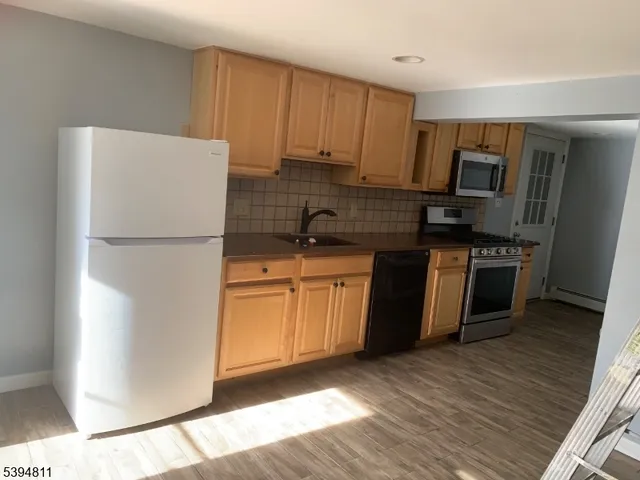 a kitchen with a refrigerator sink and microwave