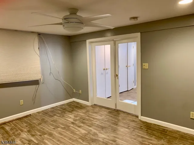 a view of a big room with closet and chandelier fan