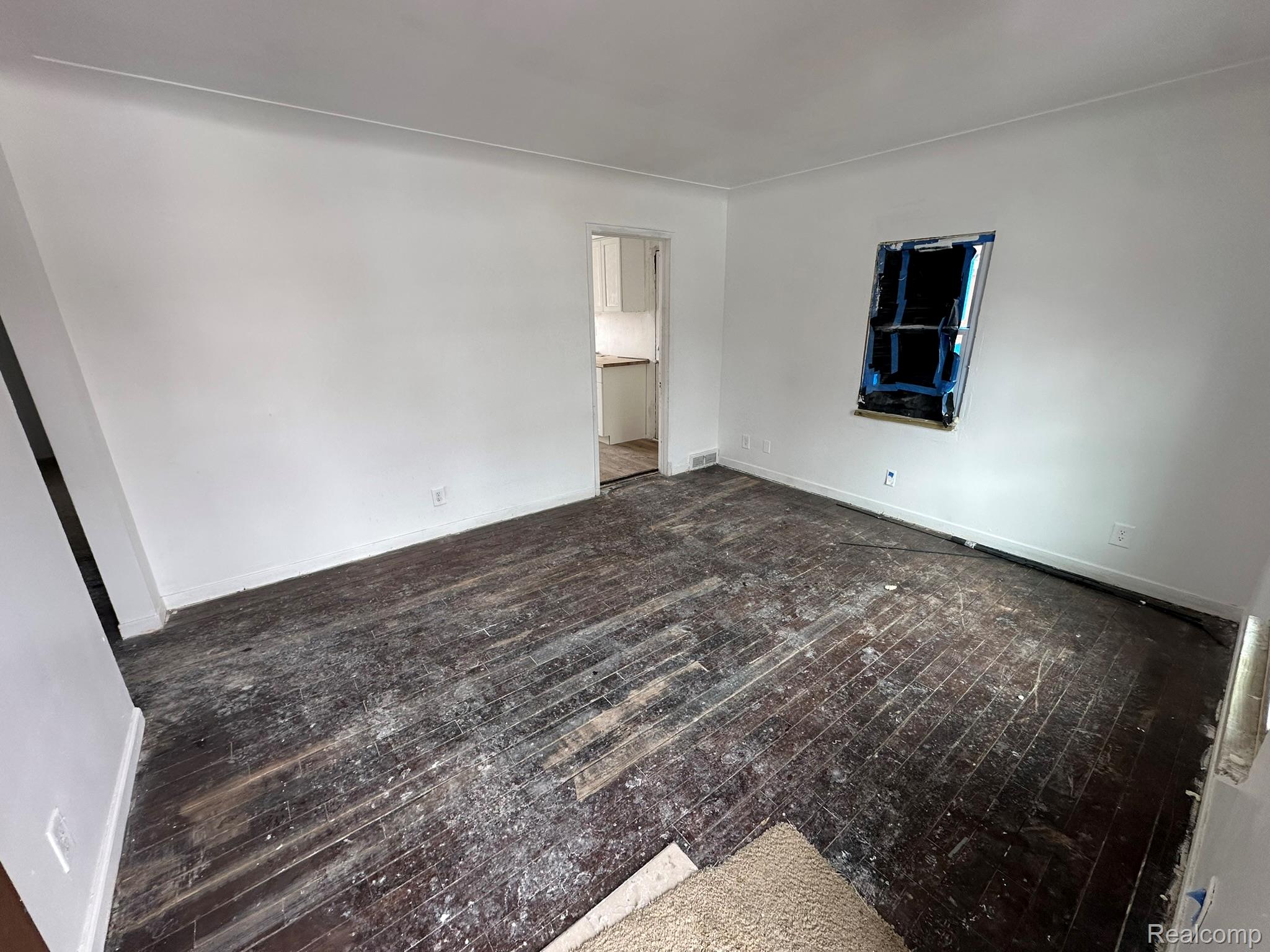 15759 Evergreen Road Detroit, MI 48223 - Photo 3 of 25 Unfurnished bedroom with dark wood-style flooring and baseboards