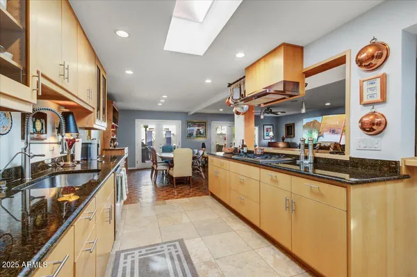 a large kitchen with stainless steel appliances lots of counter space and a sink