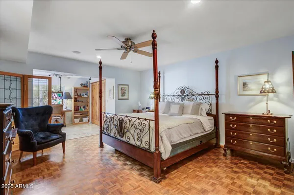 a bedroom with a bed and a chandelier