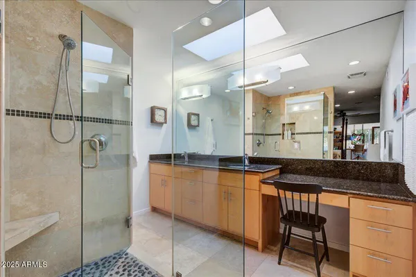 a bedroom with a bed a dresser and a window