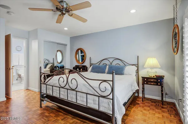 a bathroom with a granite countertop bathtub sink vanity mirror and toilet