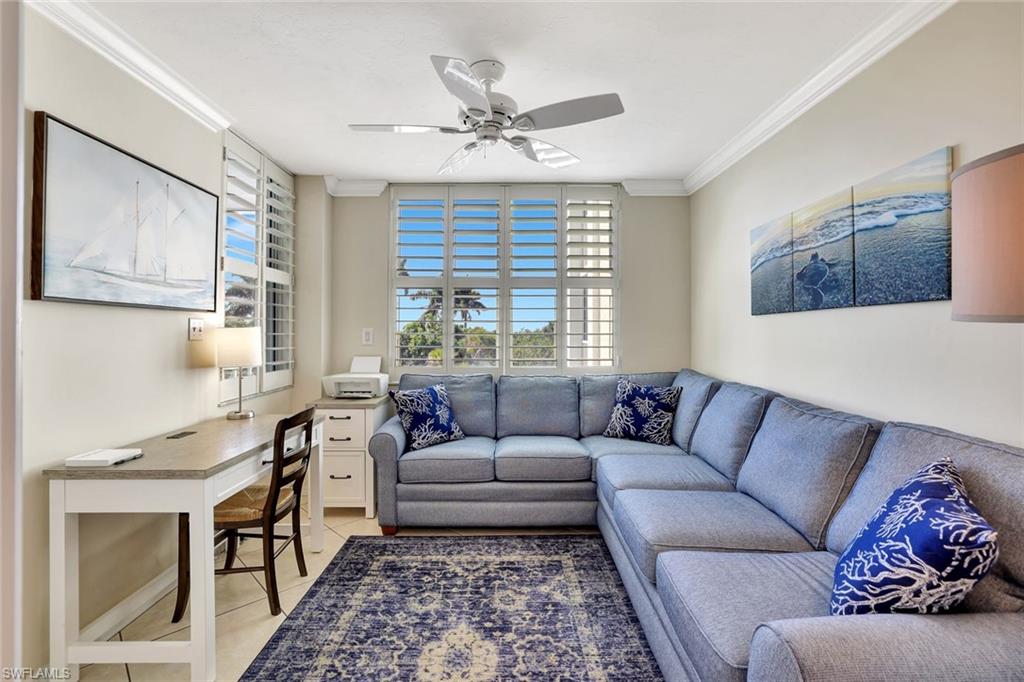 6573 Marissa Loop, Unit 302 Naples, FL 34108 - Photo 16 of 23 Living area with ornamental molding, a ceiling fan