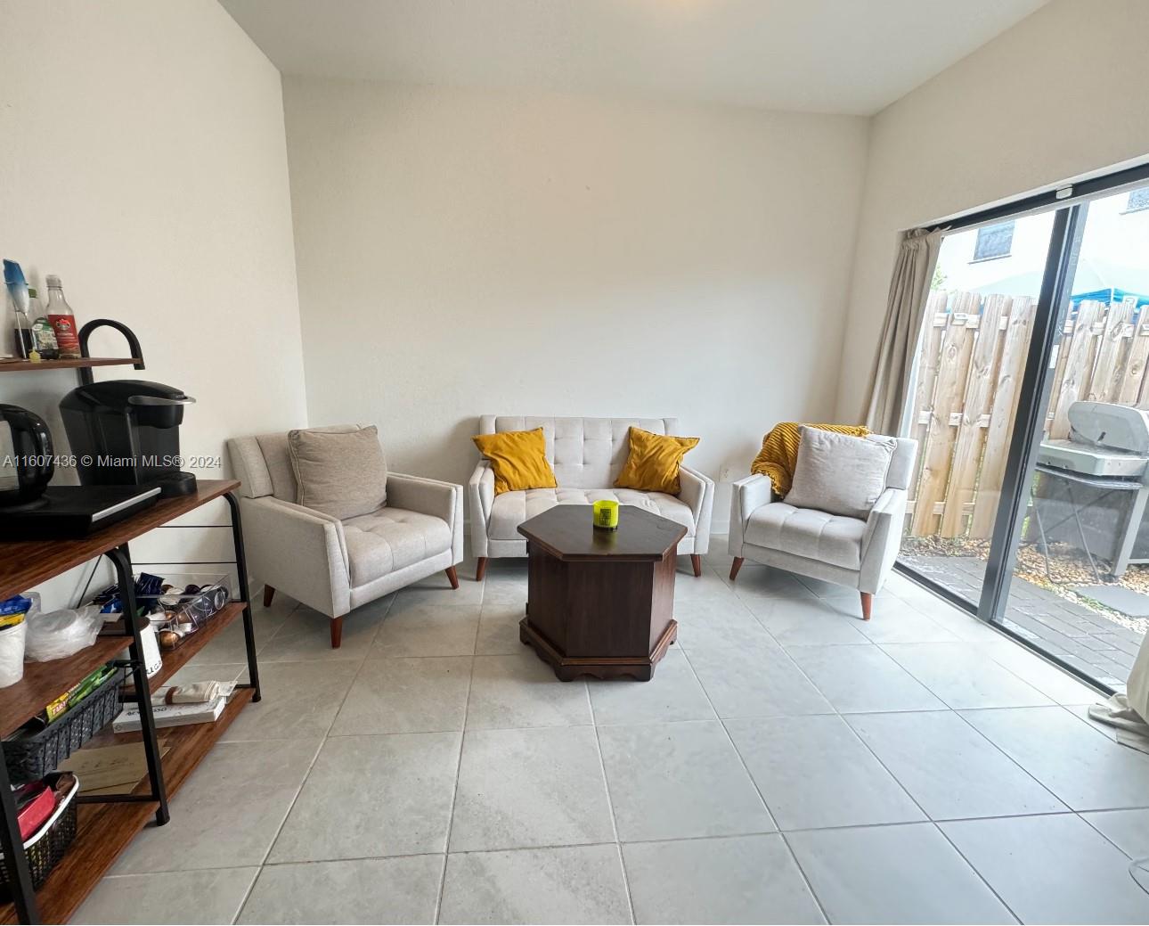 13414 Southwest 286th Street, Unit 13414 Homestead, FL 33033 - Photo 11 of 34 a living room with furniture and a flat screen tv