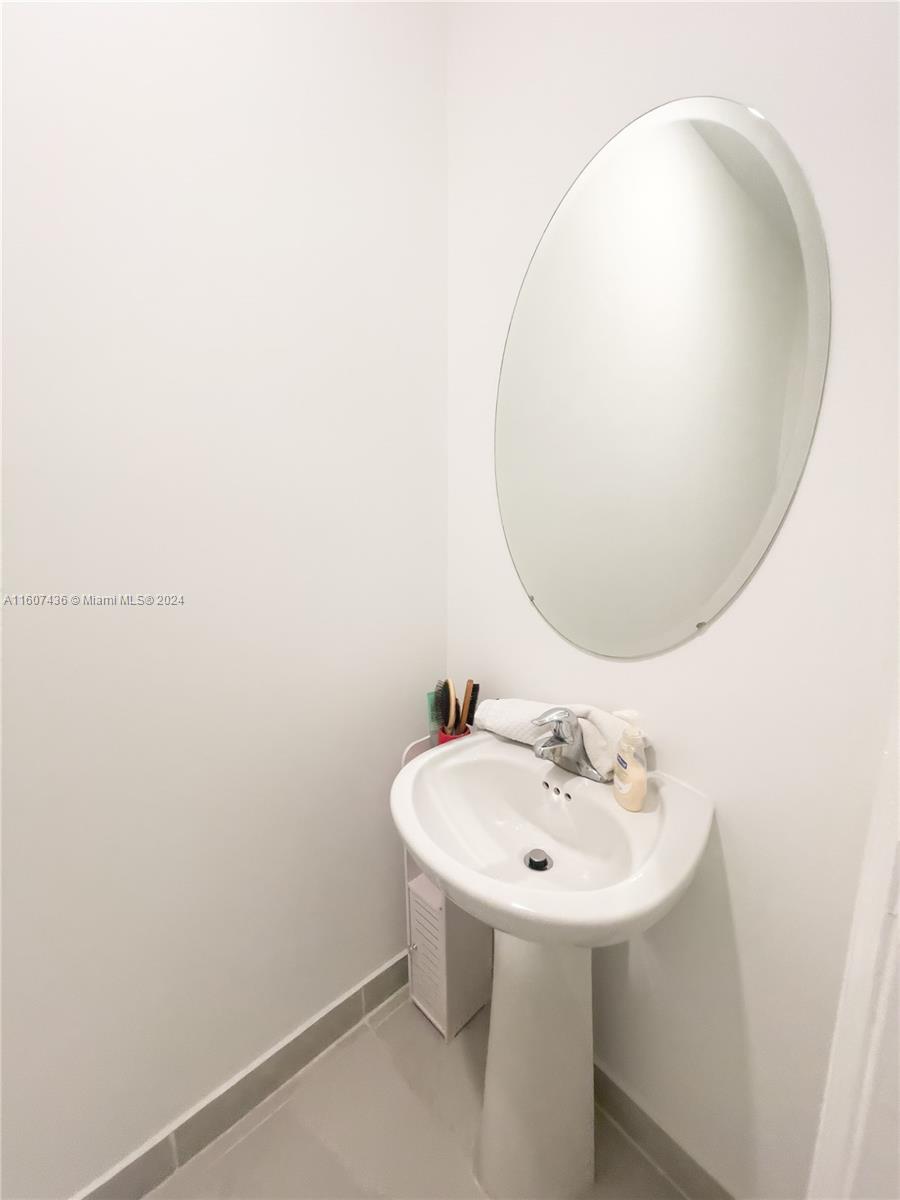 13414 Southwest 286th Street, Unit 13414 Homestead, FL 33033 - Photo 15 of 34 a bathroom with a sink and a mirror