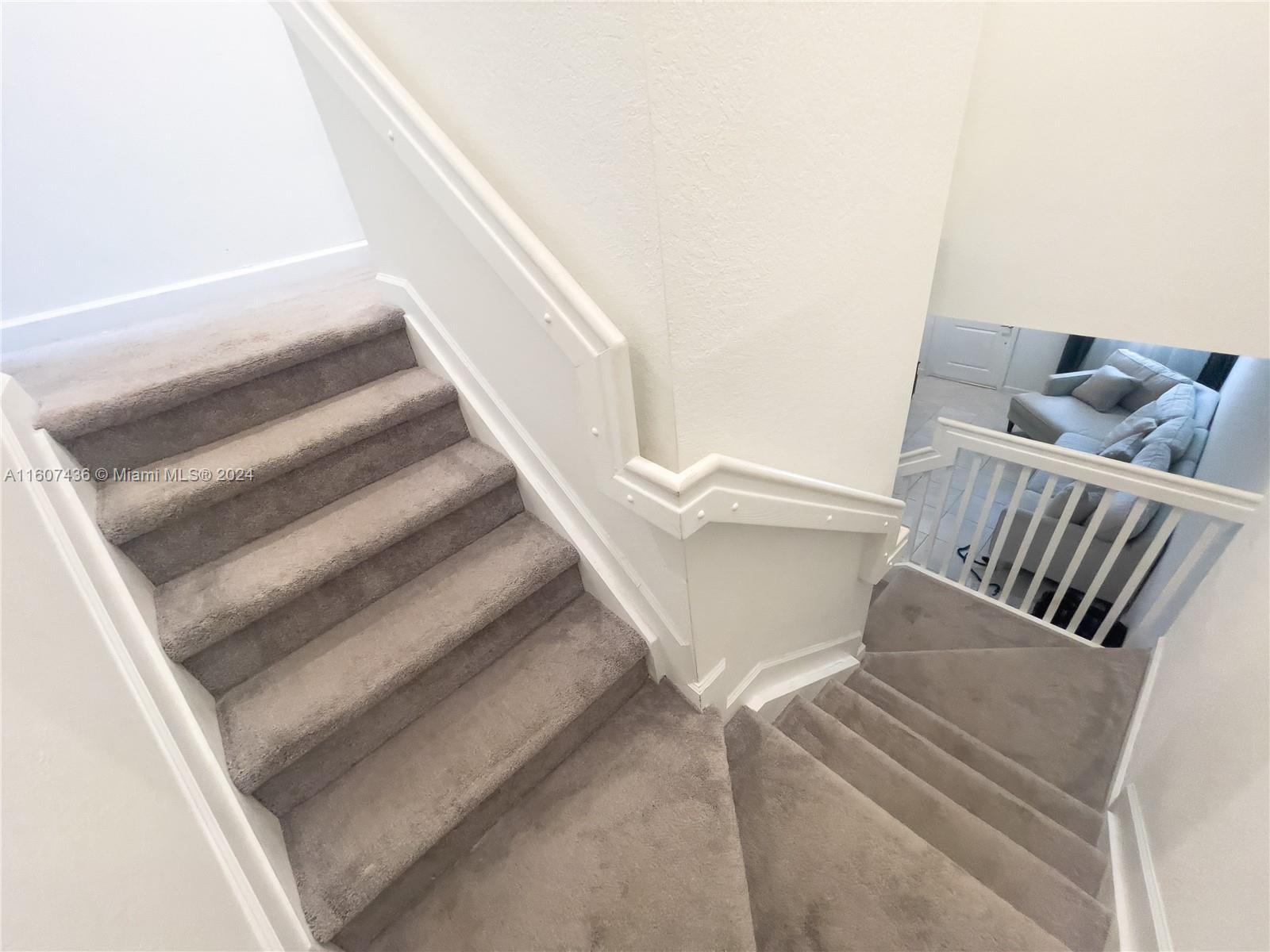 13414 Southwest 286th Street, Unit 13414 Homestead, FL 33033 - Photo 18 of 34 a view of staircase with white walls and railing