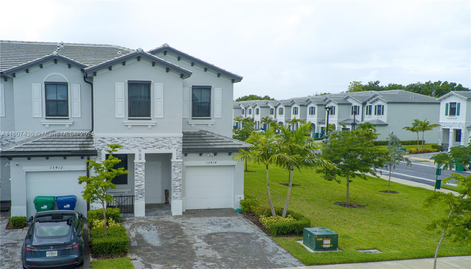13414 Southwest 286th Street, Unit 13414 Homestead, FL 33033 - Photo 2 of 34 a front view of a house with a garden