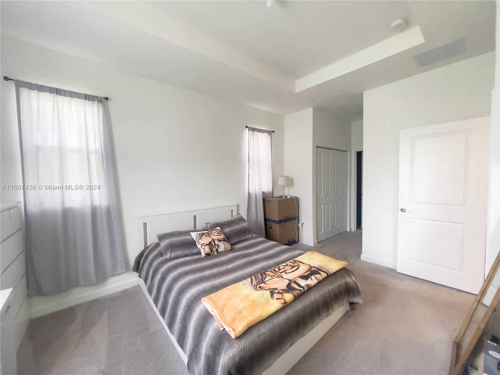 13414 Southwest 286th Street, Unit 13414 Homestead, FL 33033 - Photo 22 of 34 a bedroom with a bed and wooden floor