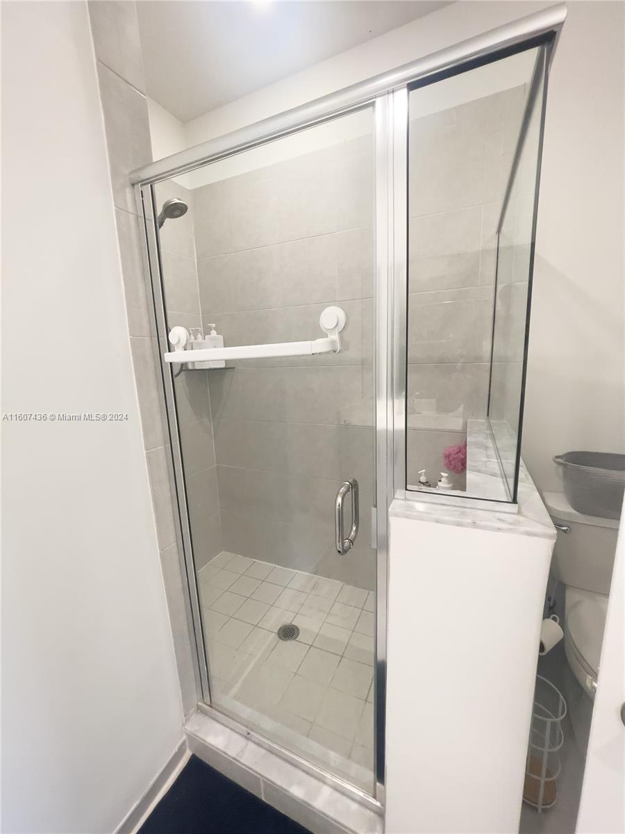 13414 Southwest 286th Street, Unit 13414 Homestead, FL 33033 - Photo 25 of 34 a bathroom with a glass shower door