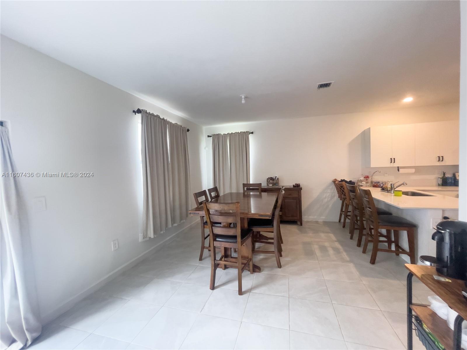 13414 Southwest 286th Street, Unit 13414 Homestead, FL 33033 - Photo 9 of 34 a dining room with furniture and window