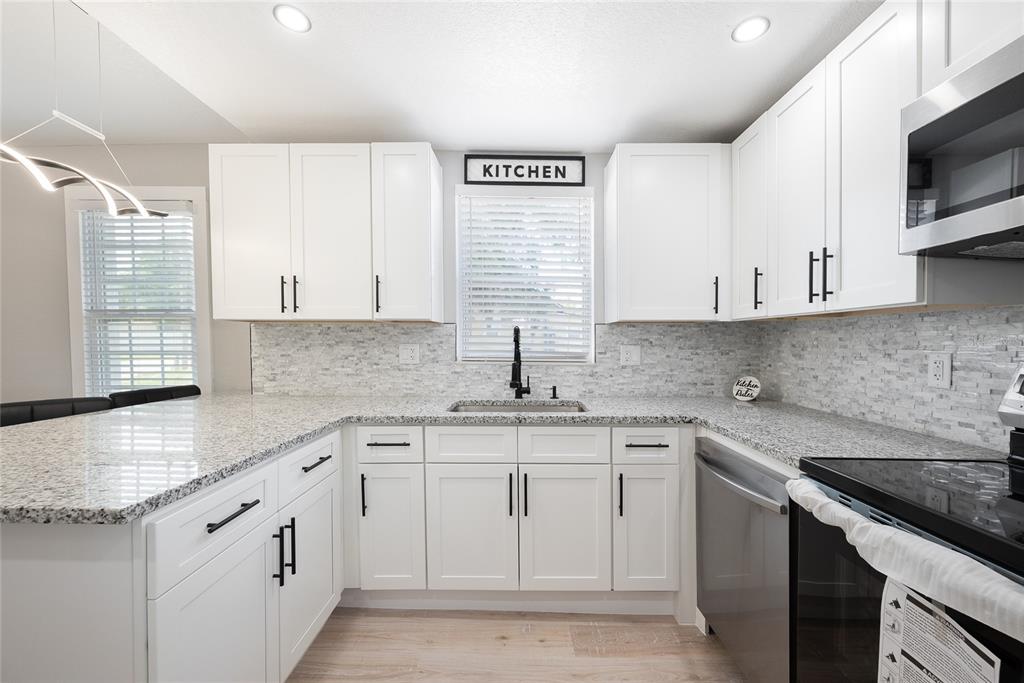 922 Delaware Avenue St. Cloud, FL 34769 - Photo 9 of 31 a kitchen with stainless steel appliances granite countertop white cabinets sink and dishwasher