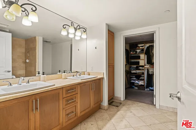a spacious bathroom with a double vanity sink mirror and shower