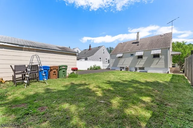 a view of a house with a backyard and a patio