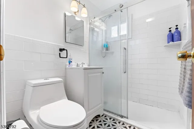a white toilet sitting next to a bathroom sink
