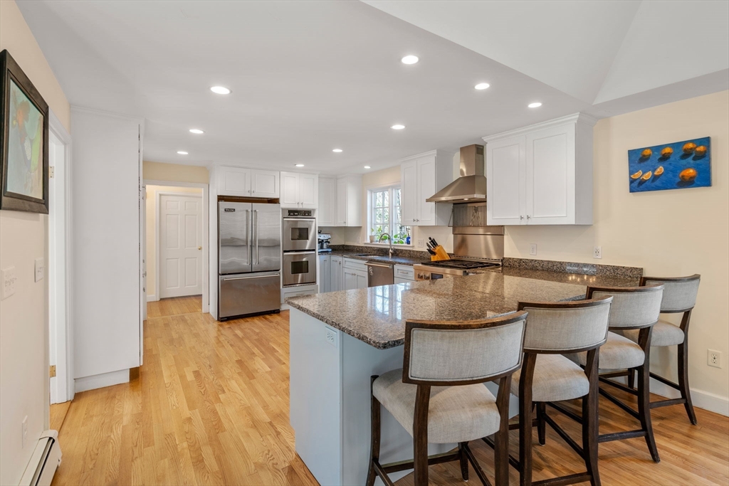 3 Goose Pond Road Lincoln, MA 01773 - Photo 5 of 37 a kitchen with stainless steel appliances granite countertop a dining table chairs refrigerator and sink