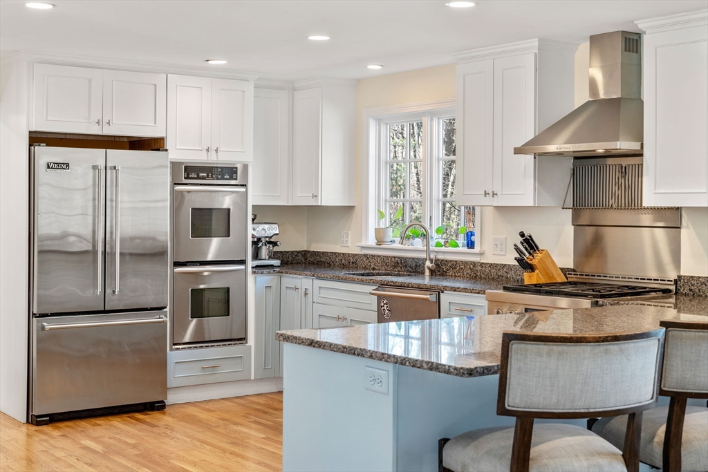 3 Goose Pond Road Lincoln, MA 01773 - Photo 6 of 37 a kitchen with kitchen island granite countertop a stove a sink and a refrigerator