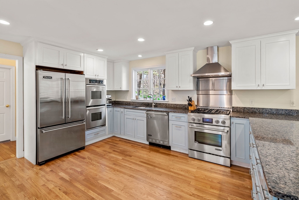 3 Goose Pond Road Lincoln, MA 01773 - Photo 8 of 37 a kitchen with granite countertop a refrigerator stove and wooden floor
