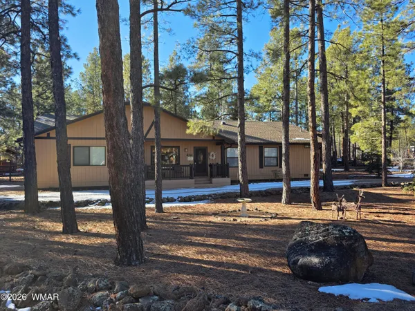 a view of a house with a large tree