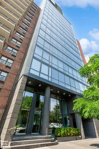 a roof deck with outdoor seating and city view