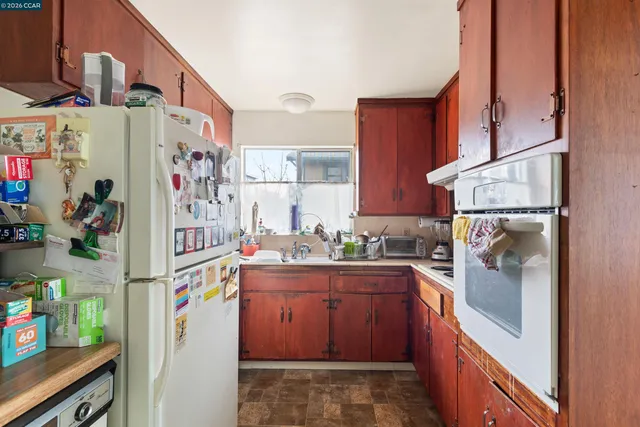 a kitchen with stainless steel appliances granite countertop a refrigerator and a stove
