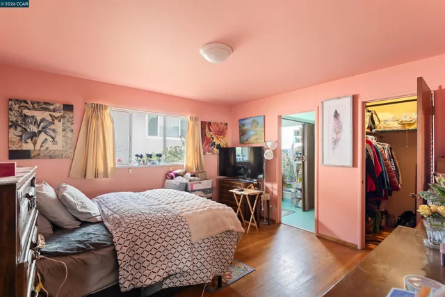 a bedroom with furniture and a flat screen tv
