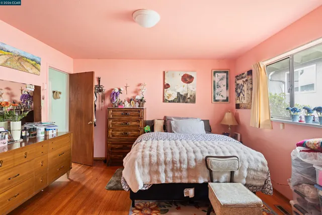 a bedroom with furniture and wooden floor