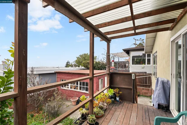 a view of balcony with a large window and wooden floor