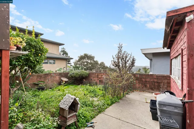 a view of backyard with outdoor seating and green space