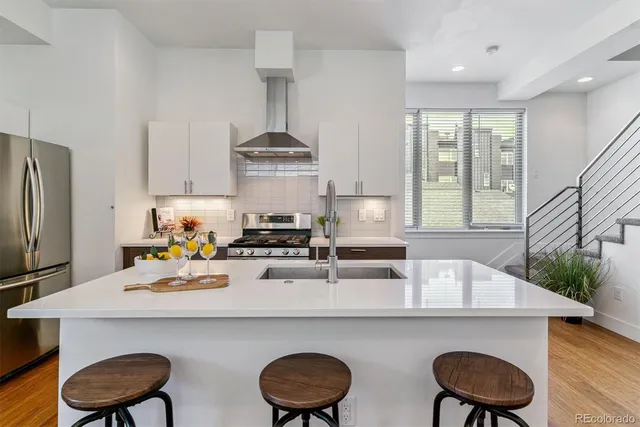 a kitchen with a table chairs stove and refrigerator