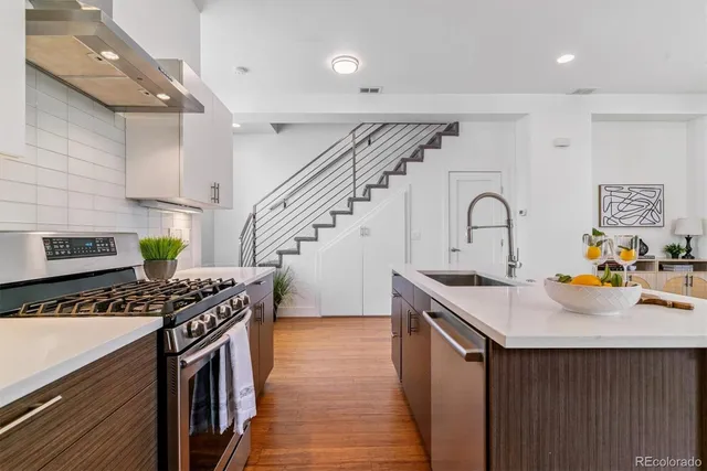a kitchen that has a sink and a stove