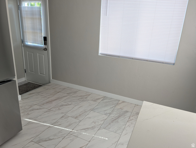 2880 Merton Way Magna, UT 84044 - Photo 5 of 30 Kitchen space featuring light gray walls, white baseboards, and wood-finish tile flooring