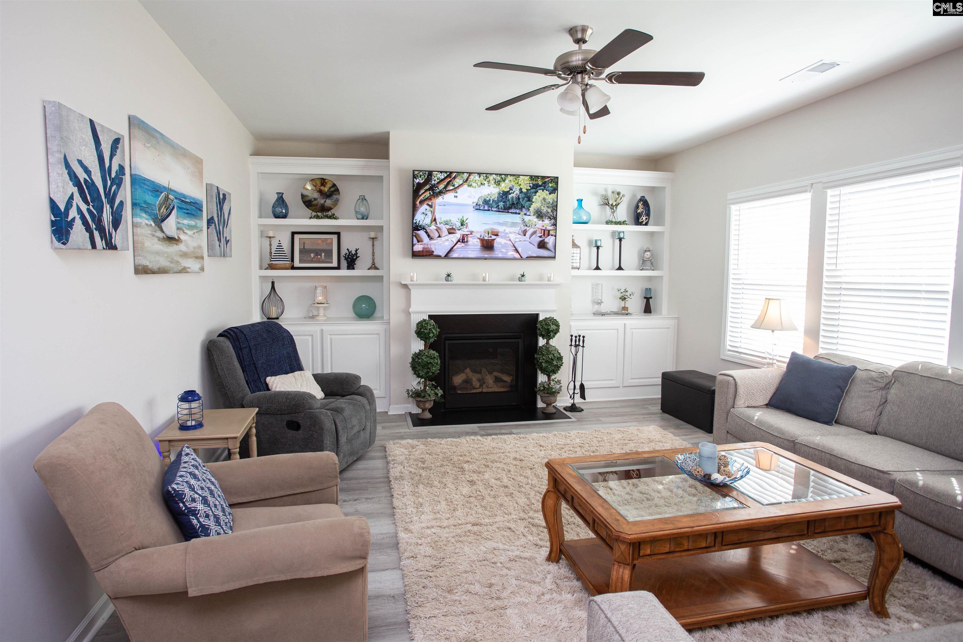 272 Shadowbrook Way Camden, SC 29020 - Photo 15 of 43 a living room with furniture a flat screen tv and a fireplace