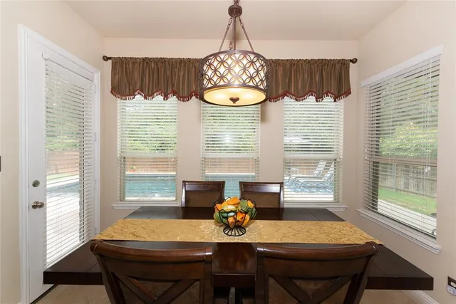 a view of a dining room with furniture and window