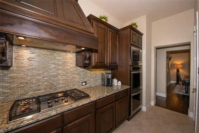 a kitchen with a stove and a refrigerator