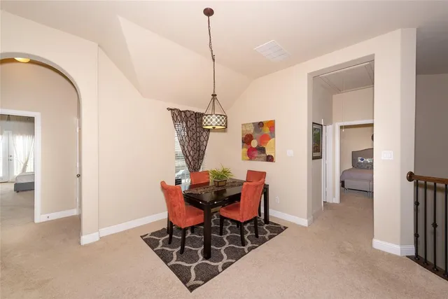a view of a dining room with furniture and a chandelier