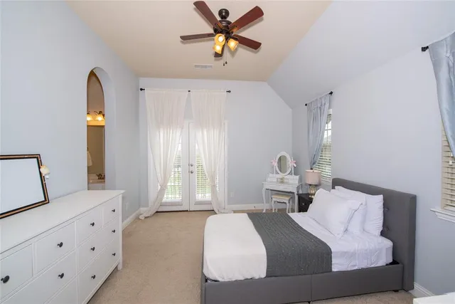 a bedroom with a bed and window