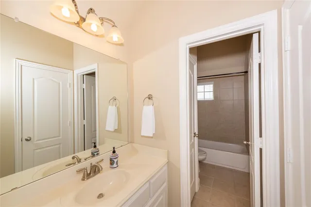 a bathroom with a sink a mirror and a shower