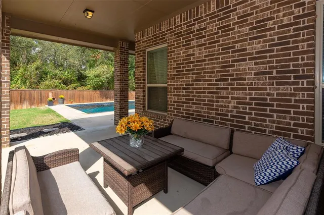 a view of a patio with couches and a table and chairs