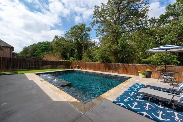 a view of a backyard with sitting area