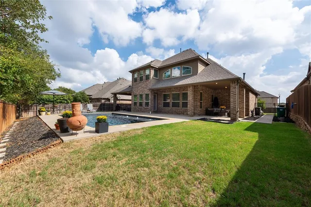 a view of a house with backyard porch and sitting area