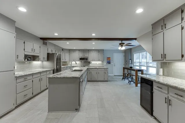 a kitchen with lots of counter top space and stainless steel appliances