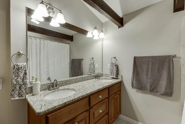 a bedroom with a bed and a ceiling fan